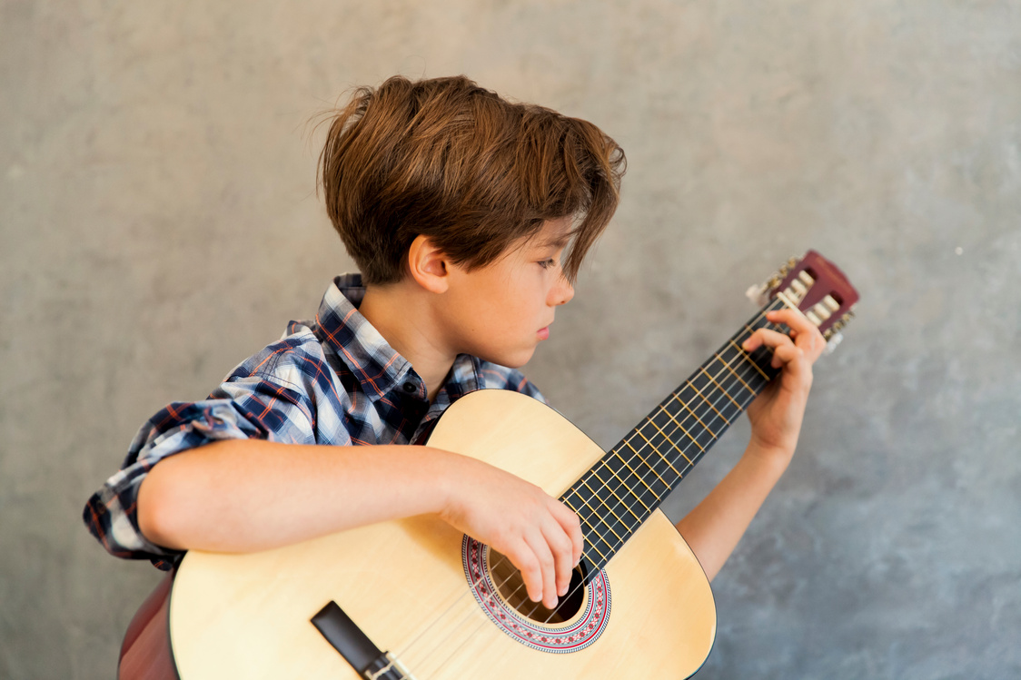 Teen Boy Playing Acoustic Guitar