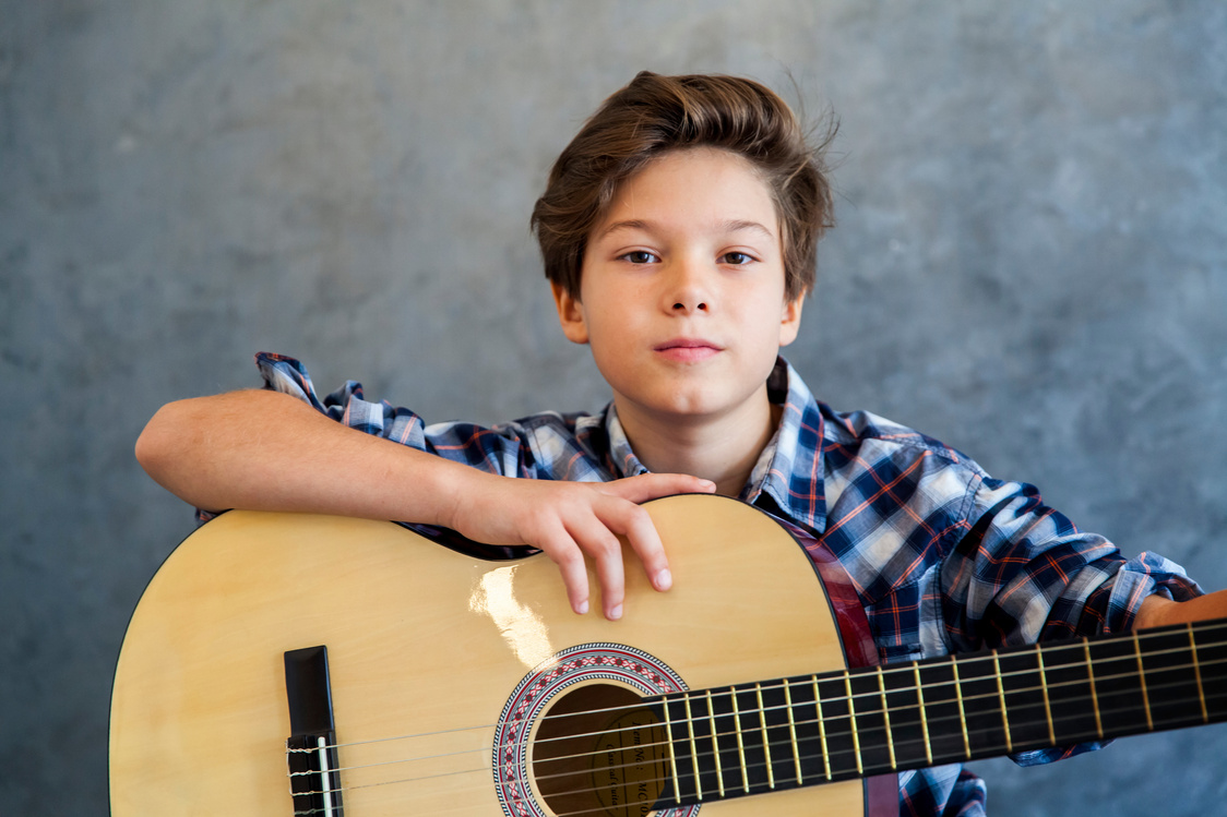 Teenage Boy Playing His  Guitar