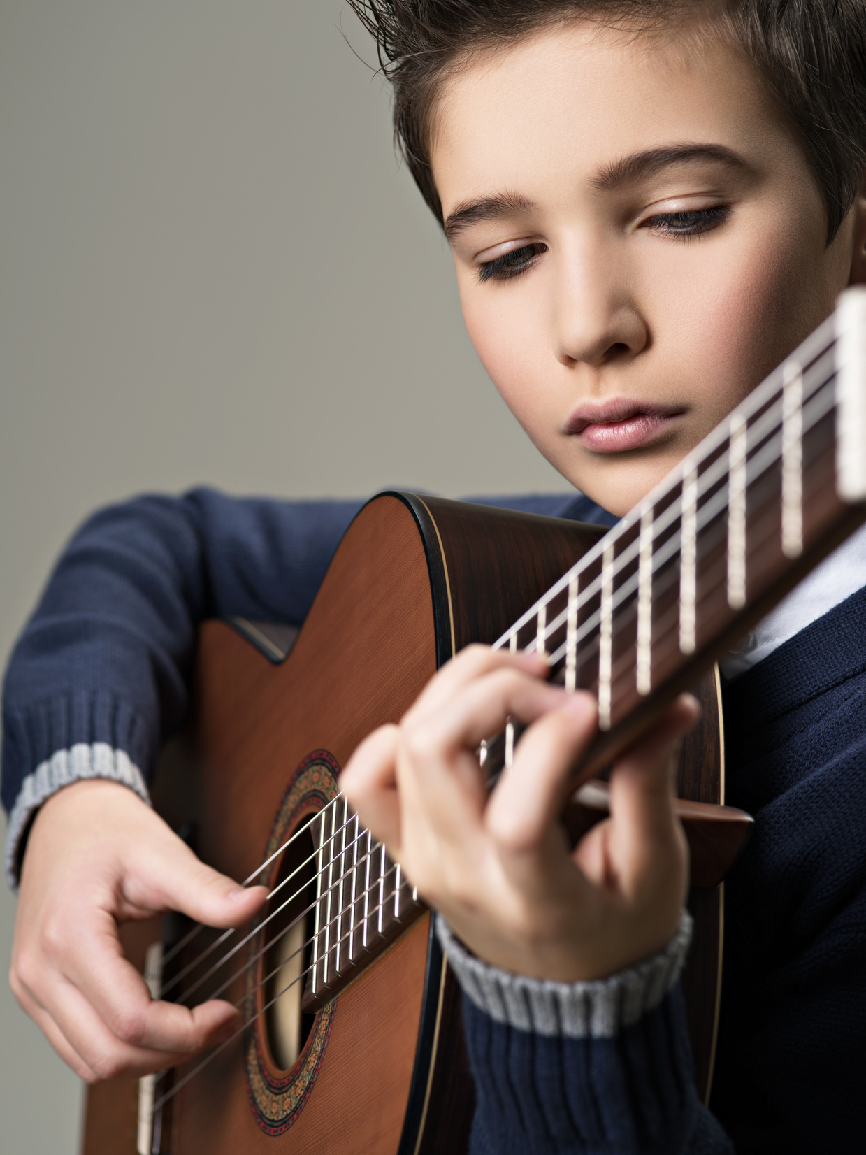 Caucasian  Boy Playing on Acoustic Guitar.